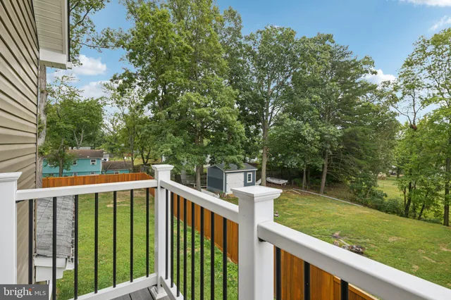 a view of a wooden deck and backyard