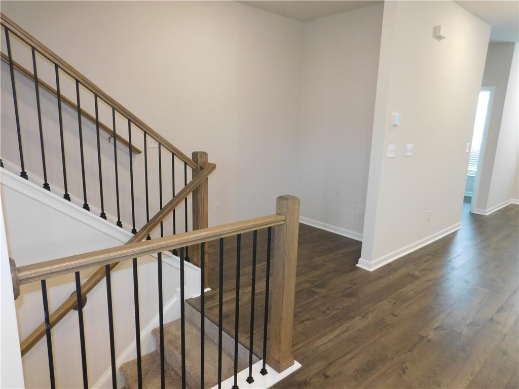 1626 Halbrook Place Southwest Marietta, GA 30008 - Photo 12 of 43 a view of staircase with wooden floor and white walls