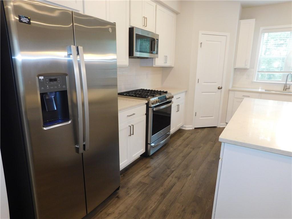 1626 Halbrook Place Southwest Marietta, GA 30008 - Photo 15 of 43 a kitchen with stainless steel appliances granite countertop a refrigerator a sink and a stove