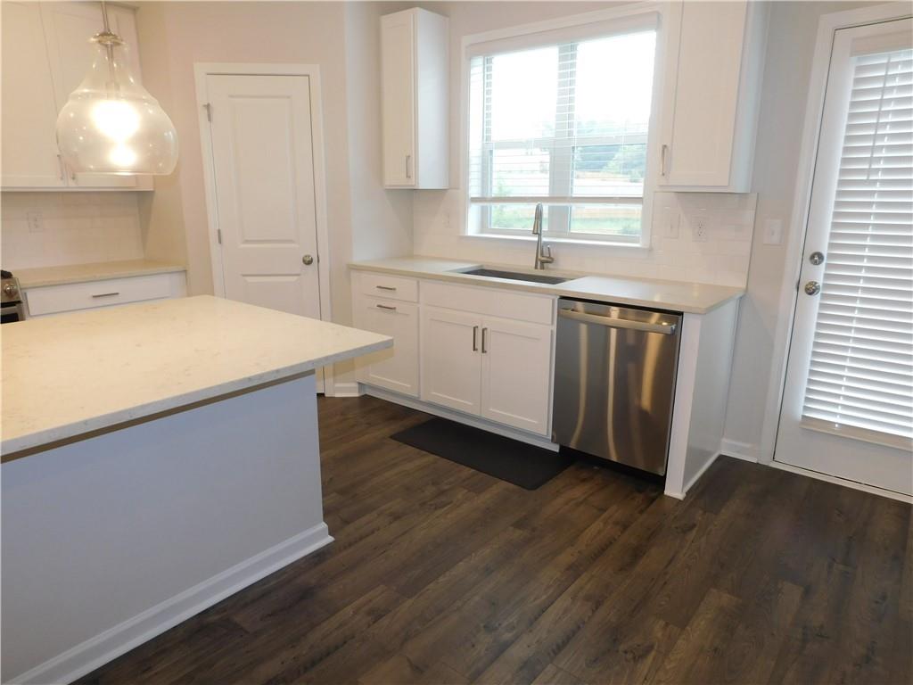 1626 Halbrook Place Southwest Marietta, GA 30008 - Photo 17 of 43 a kitchen with a sink a window and cabinets