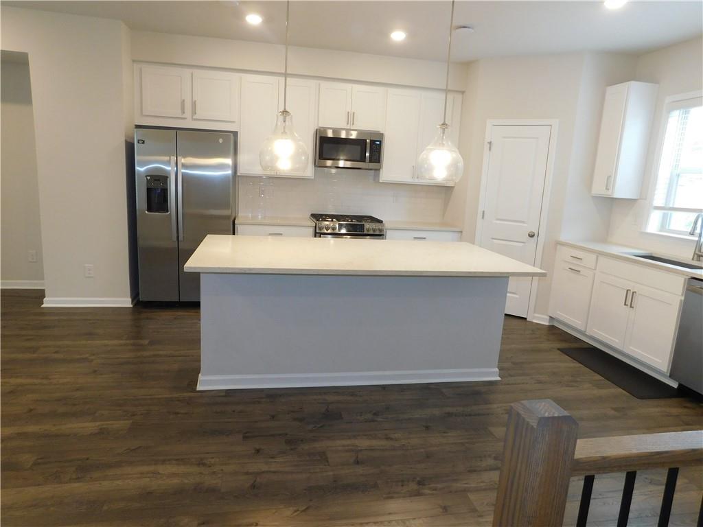 1626 Halbrook Place Southwest Marietta, GA 30008 - Photo 18 of 43 a view of kitchen with stainless steel appliances wooden floor sink stove and granite counter top