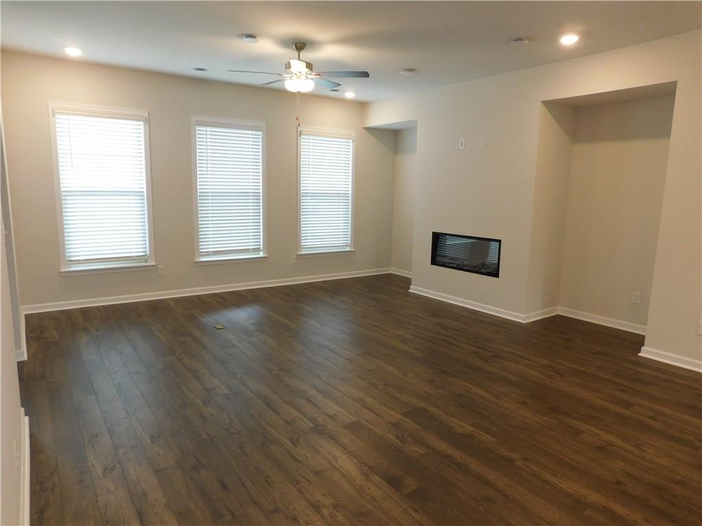 1626 Halbrook Place Southwest Marietta, GA 30008 - Photo 20 of 43 an empty room with wooden floor and windows