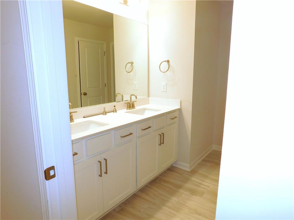 1626 Halbrook Place Southwest Marietta, GA 30008 - Photo 34 of 43 a bathroom with a sink and a mirror