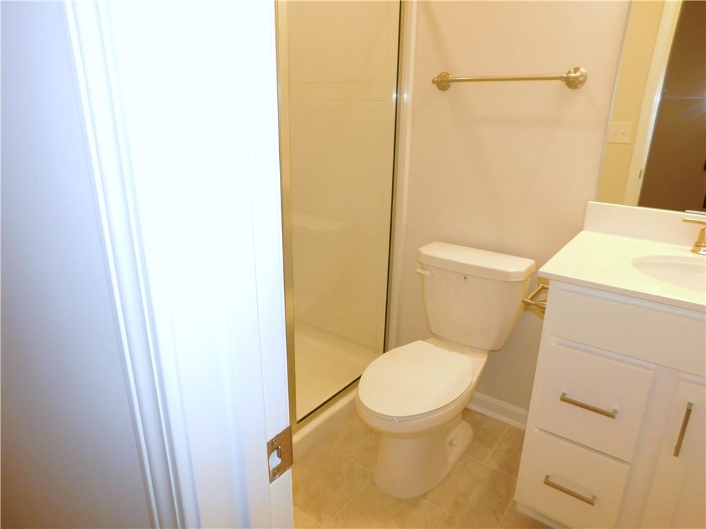 1626 Halbrook Place Southwest Marietta, GA 30008 - Photo 8 of 43 a white toilet sitting next to a small sink