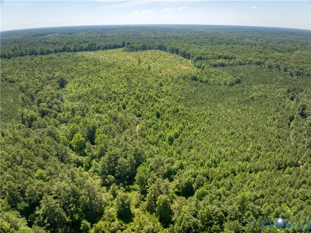 a view of a field with an ocean view