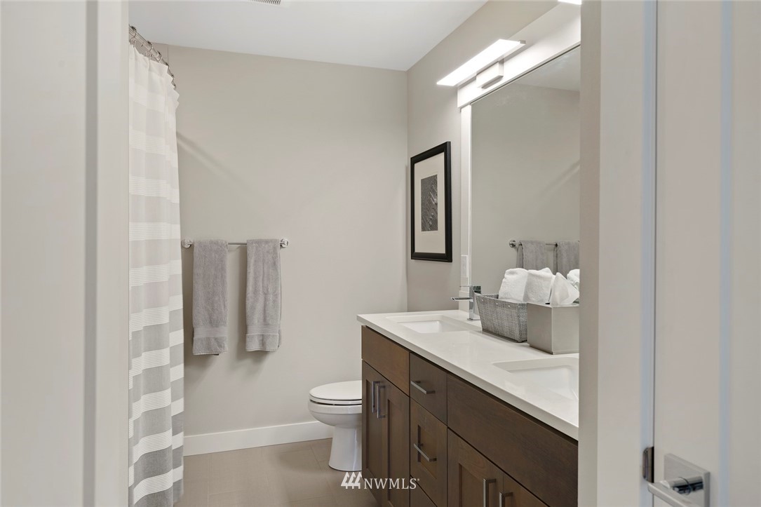 19824 86th Place West Edmonds, WA 98026 - Photo 27 of 40 a bathroom with a sink toilet vanity and shower