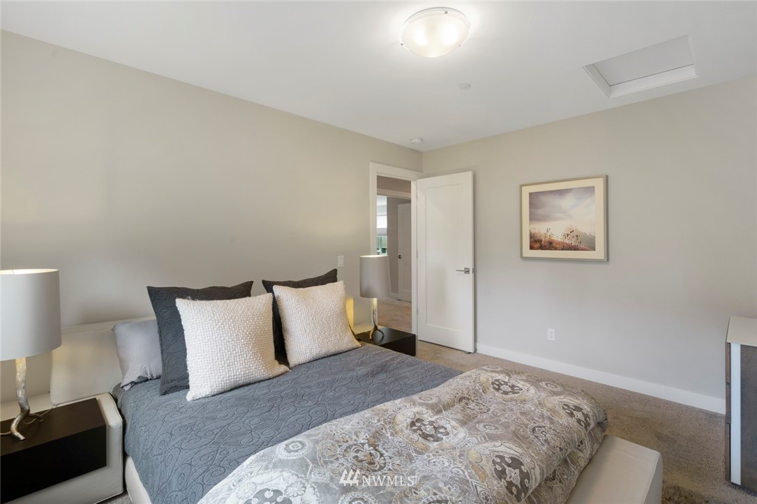 19824 86th Place West Edmonds, WA 98026 - Photo 29 of 40 a bedroom with a bed and a lamp