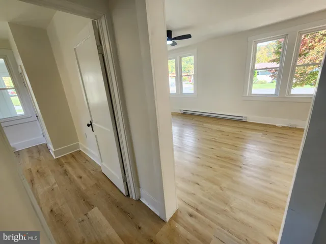 a view of empty room with wooden floor