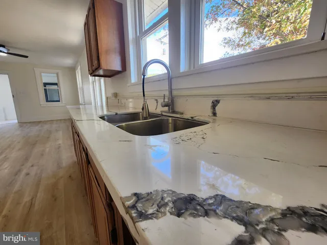 a view of a kitchen with wooden floor and staircase