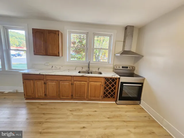 a kitchen with a sink and a stove top oven