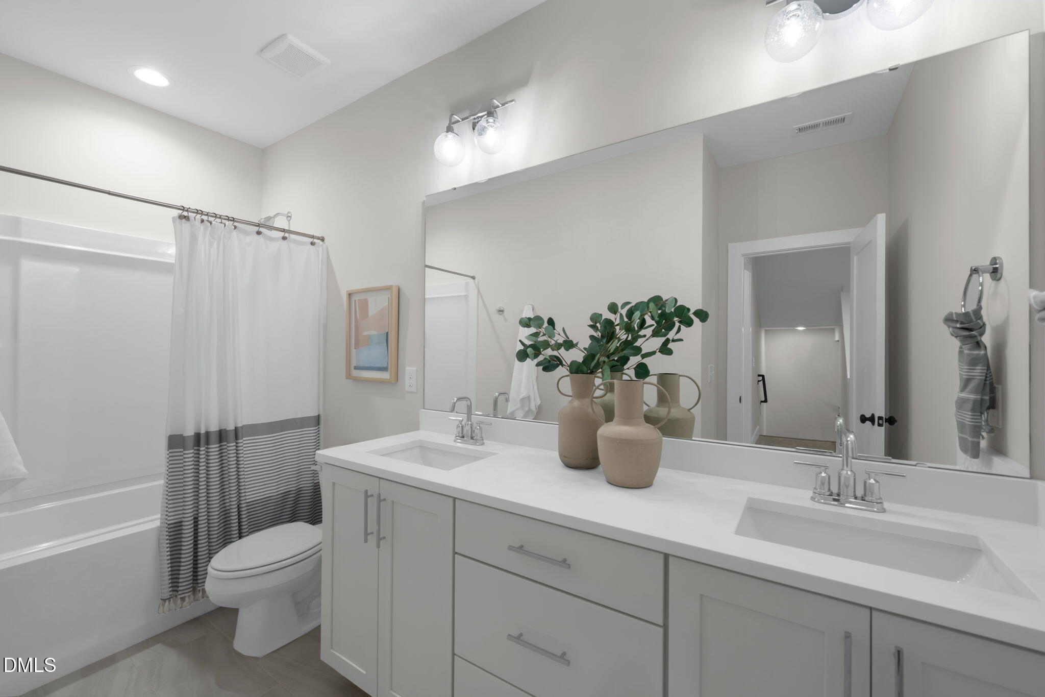 964 Double Helix Road Apex, NC 27523 - Photo 23 of 37 a bathroom with a double vanity sink toilet and shower