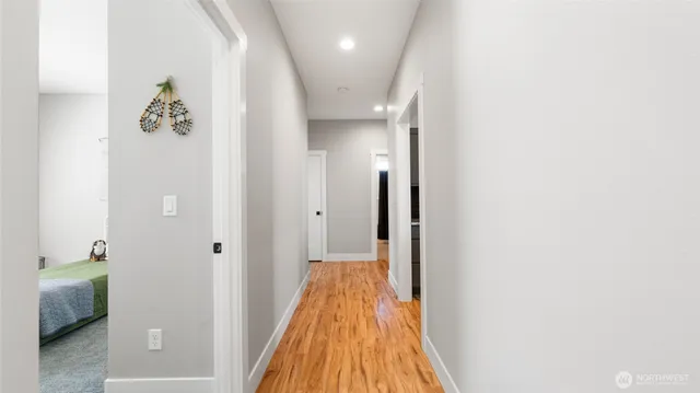 a view of a hallway with wooden floor and staircase