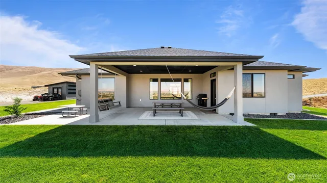 a view of a patio with table and chairs under an umbrella