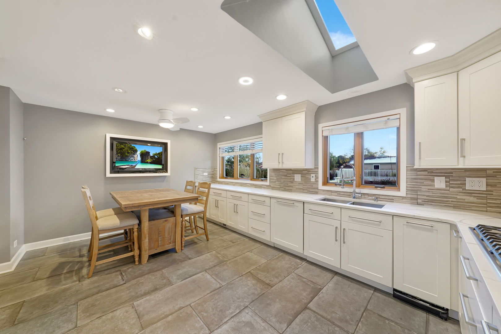4-n040 Nugent Street Addison, IL 60101 - Photo 12 of 48 a kitchen with a sink and chairs