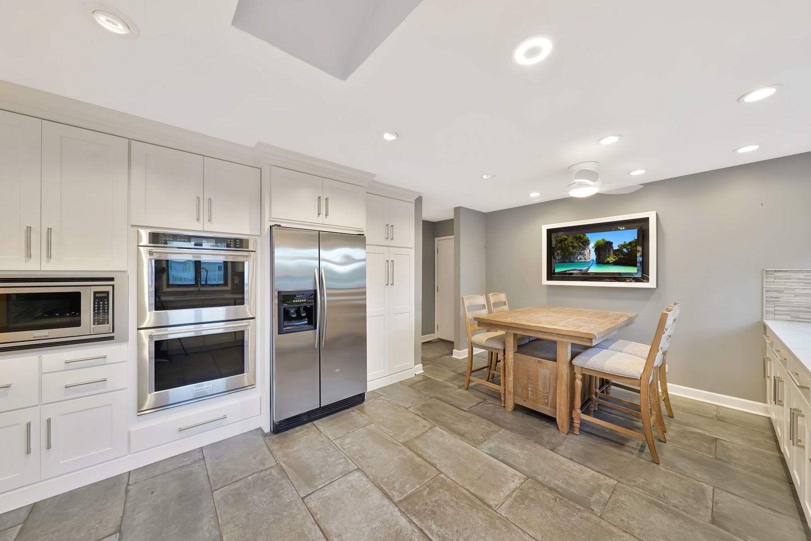 4-n040 Nugent Street Addison, IL 60101 - Photo 13 of 48 a kitchen with stainless steel appliances a stove a microwave a sink a refrigerator and cabinets