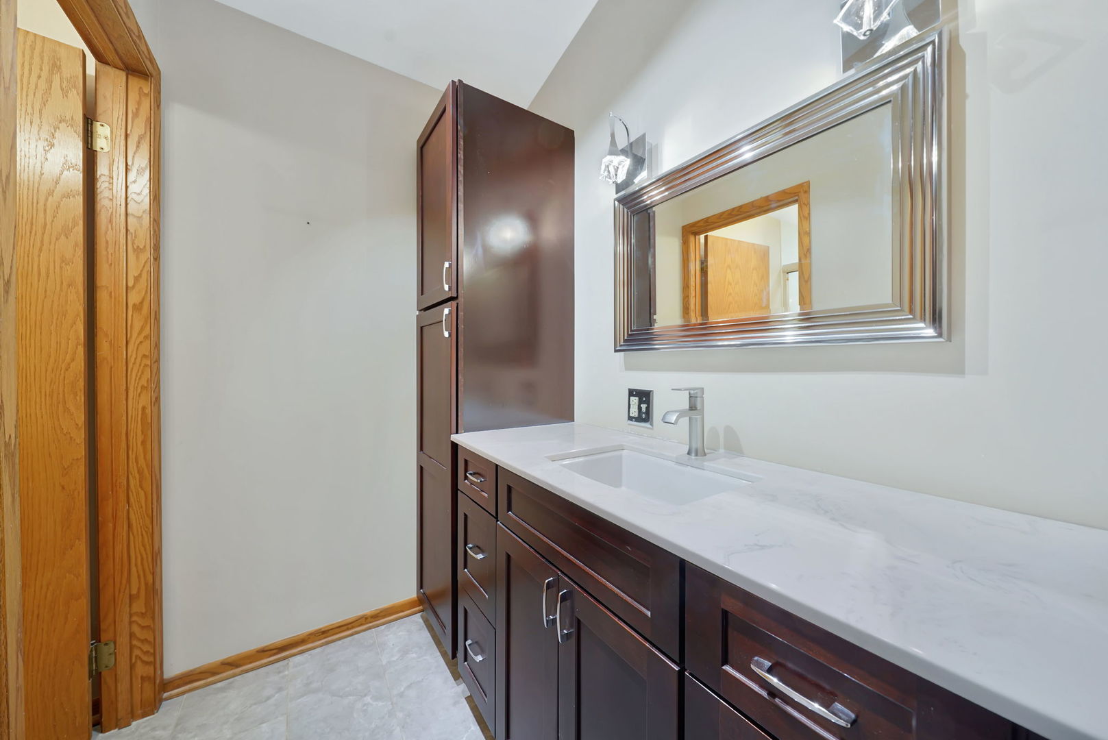 4-n040 Nugent Street Addison, IL 60101 - Photo 19 of 48 a bathroom with a sink a vanity and a mirror