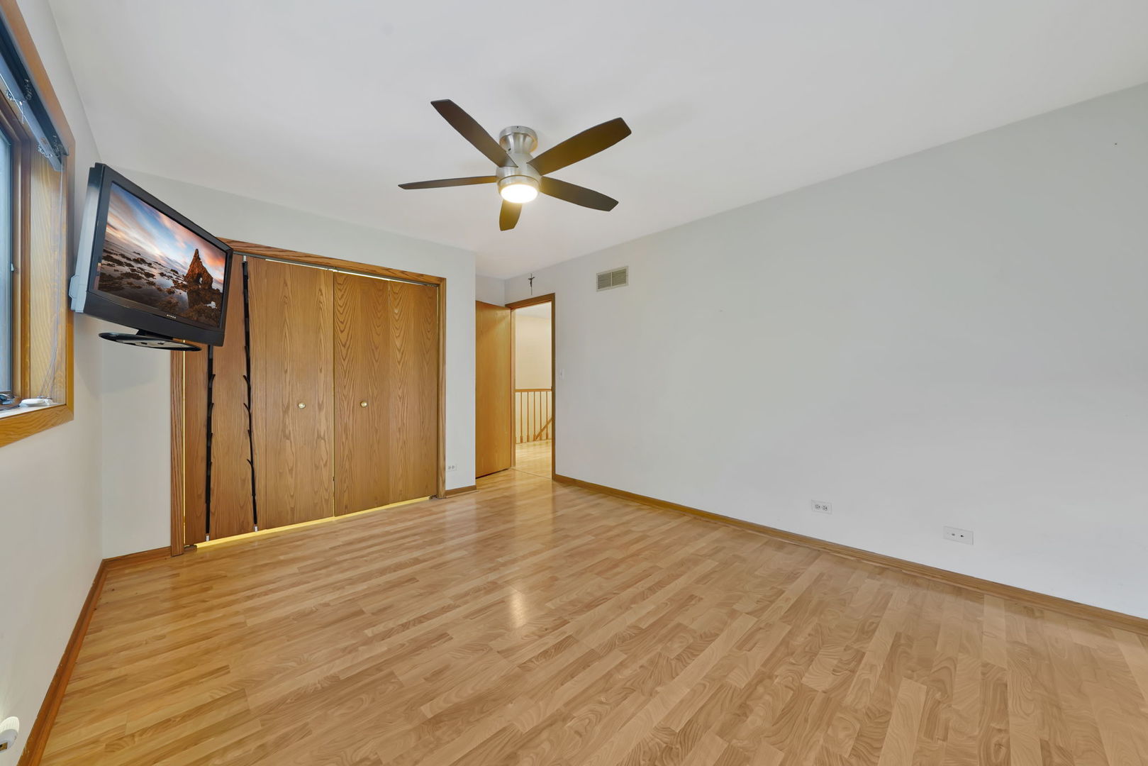 4-n040 Nugent Street Addison, IL 60101 - Photo 21 of 48 a view of empty room with wooden floor and fan