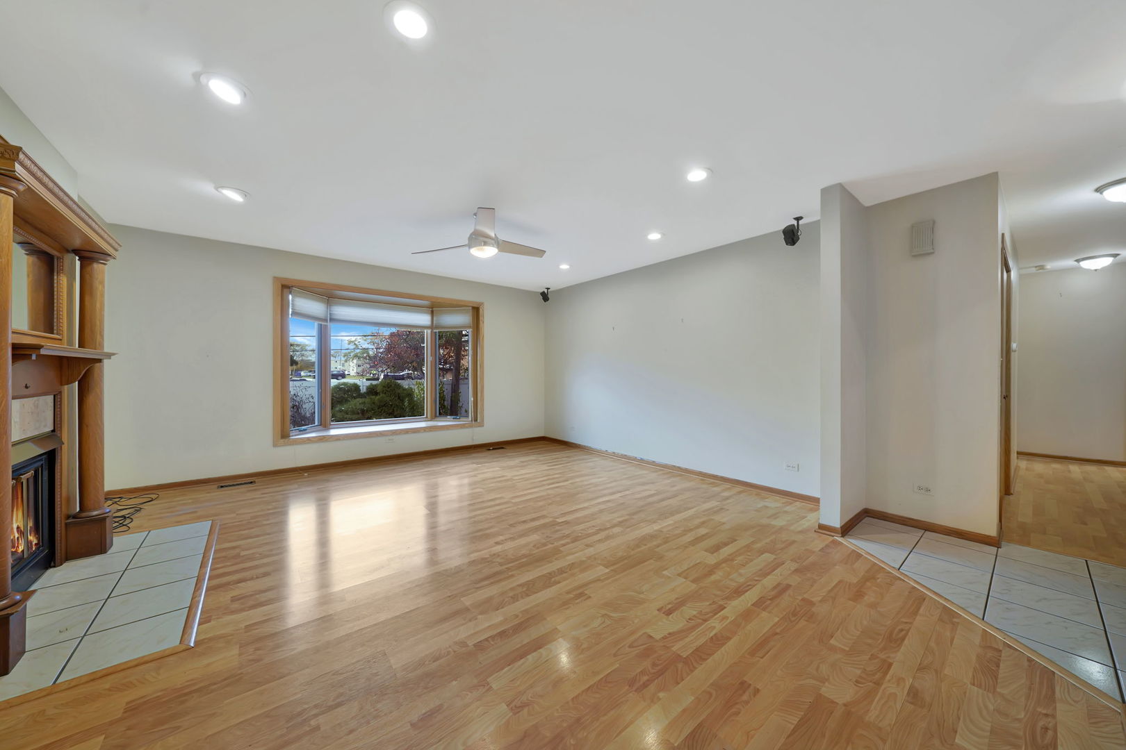 4-n040 Nugent Street Addison, IL 60101 - Photo 4 of 48 a view of an empty room with a window and wooden floor