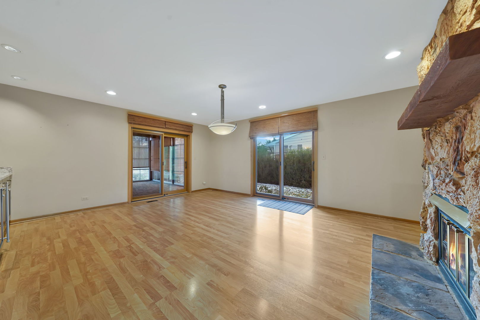 4-n040 Nugent Street Addison, IL 60101 - Photo 7 of 48 a view of an empty room with wooden floor kitchen view and a window