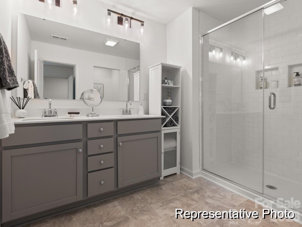 325 Drawbar Drive, Unit 98 Clover, SC 29710 - Photo 14 of 17 a bathroom with a sink a mirror and shower