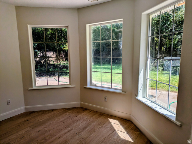441 Main Street Hurricane, UT 84737 - Photo 22 of 29 Bright interior space featuring multiple grid-pattern windows, wood-finish flooring, and crisp white trim