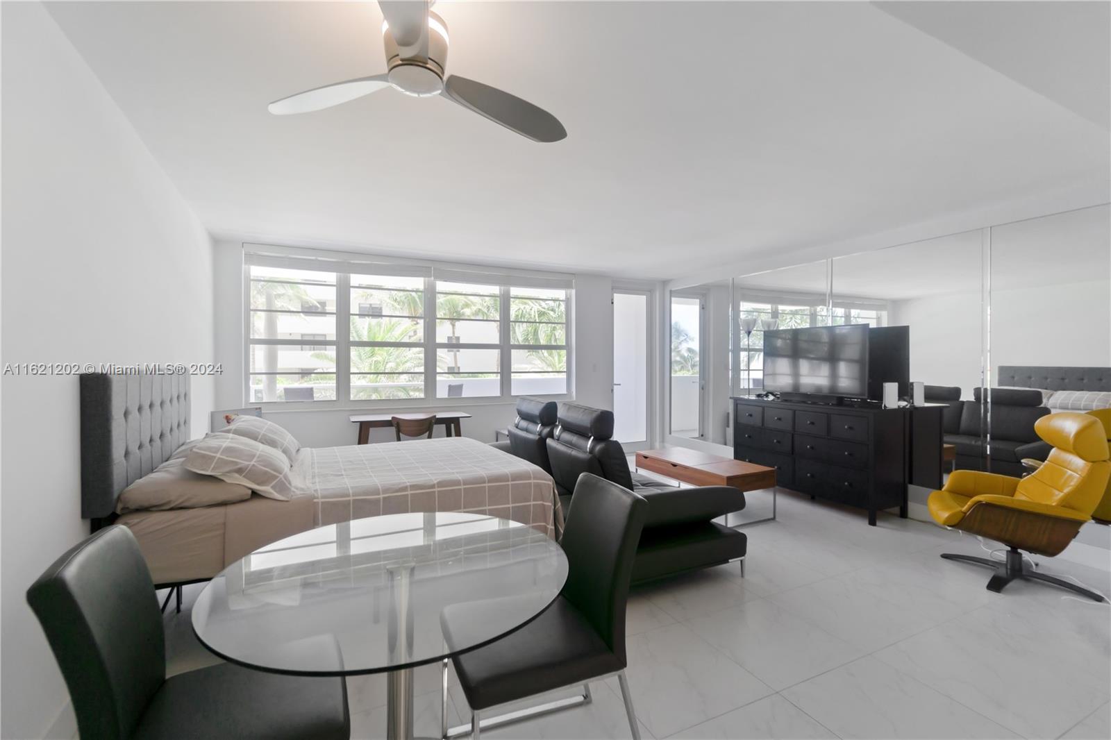 100 Lincoln Road, Unit 436 Miami Beach, FL 33139 - Photo 2 of 11 a living room with furniture and a large window