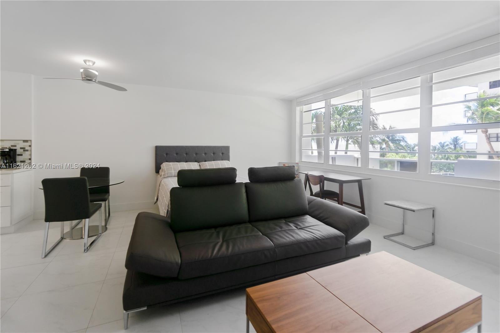 100 Lincoln Road, Unit 436 Miami Beach, FL 33139 - Photo 3 of 11 a living room with furniture and a large window