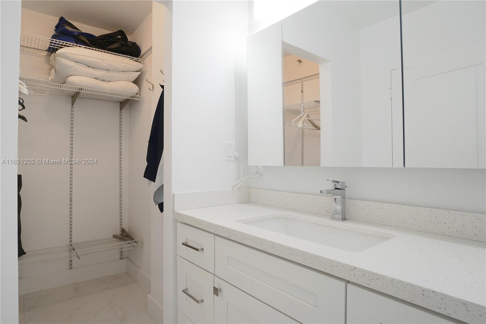 100 Lincoln Road, Unit 436 Miami Beach, FL 33139 - Photo 9 of 11 a bathroom with a sink and a mirror