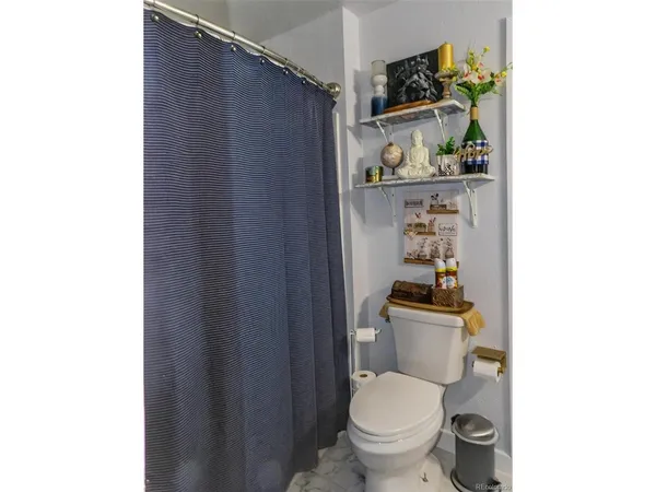 a white toilet sitting next to a bathroom sink