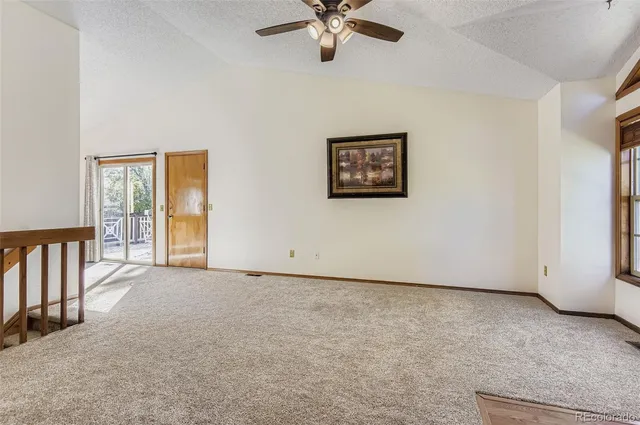 a view of a livingroom with a ceiling fan and window