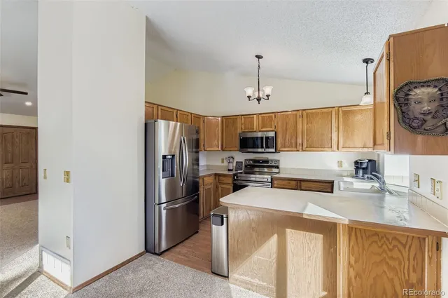 a kitchen with stainless steel appliances a refrigerator stove and sink