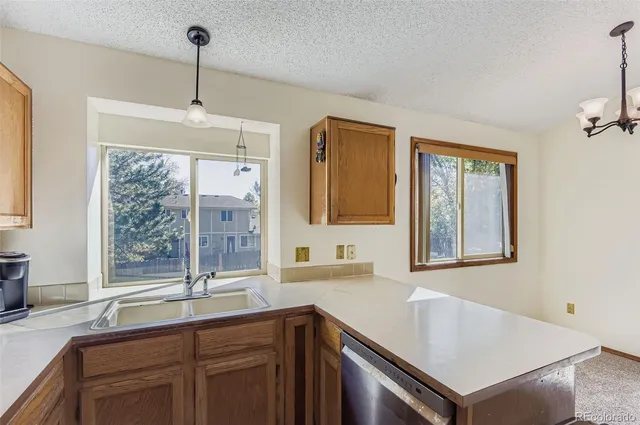 a kitchen with a sink a center island and windows