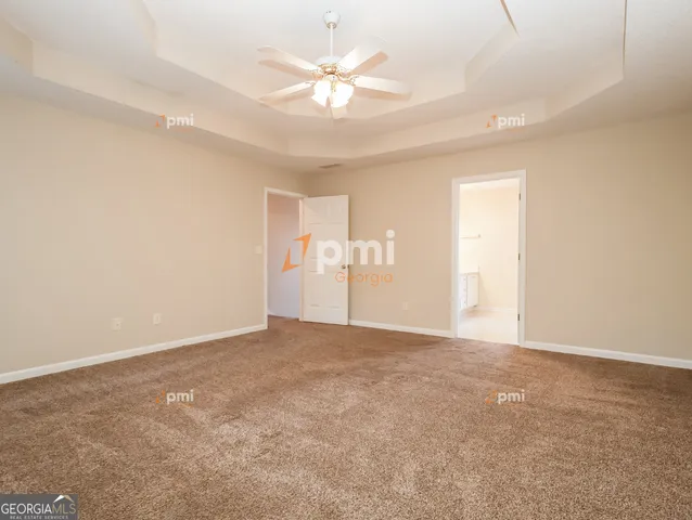 a view of an empty room with a ceiling fan