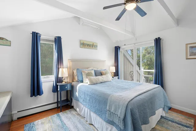 a bedroom with a bed and a large mirror