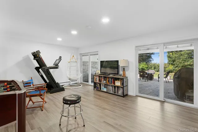 a view of a livingroom with furniture and a flat screen tv