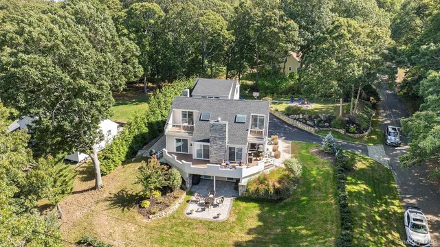 an aerial view of a house with a yard basket ball court and outdoor seating