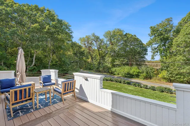a view of roof deck with furniture and trees
