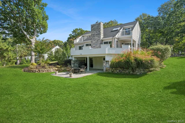 a view of a house with sitting area and garden