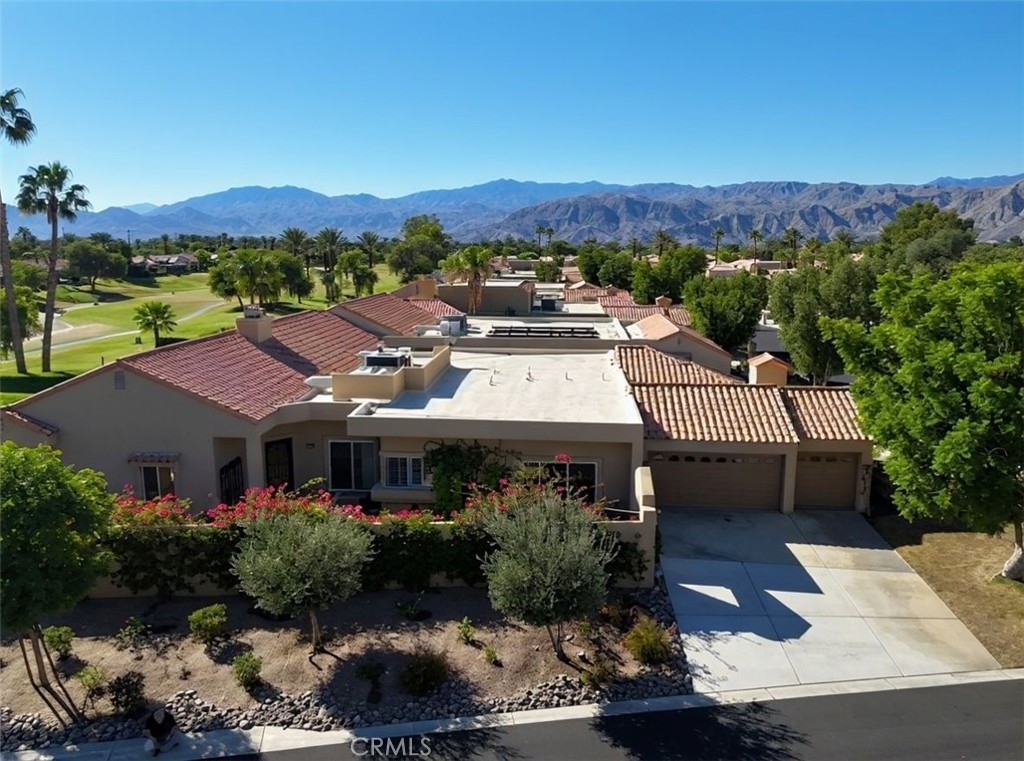48 Oak Tree Drive Rancho Mirage, CA 92270 - Photo 16 of 31 a front view of a house with a yard and mountain view in back