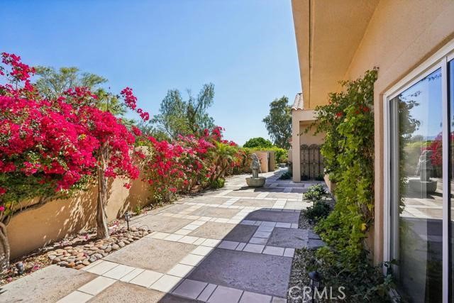 48 Oak Tree Drive Rancho Mirage, CA 92270 - Photo 19 of 31 a view of a pathway with flower plants