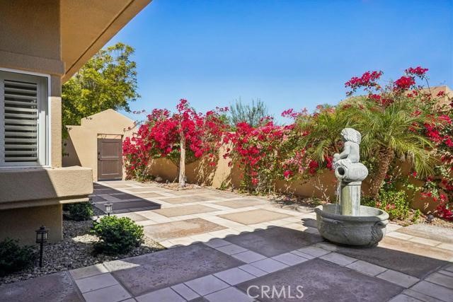 48 Oak Tree Drive Rancho Mirage, CA 92270 - Photo 23 of 31 a front view of a house with a yard