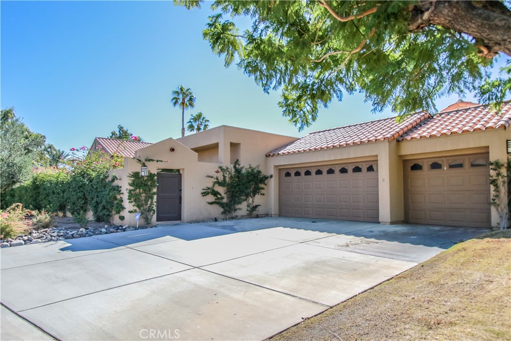 48 Oak Tree Drive Rancho Mirage, CA 92270 - Photo 29 of 31 a front view of a house with a garage