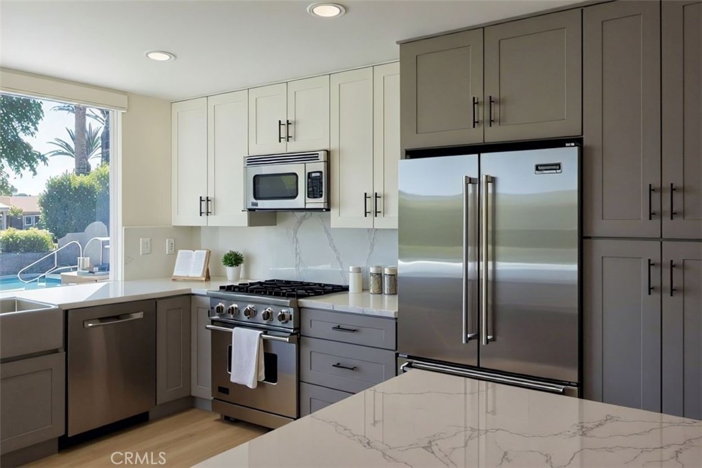 48 Oak Tree Drive Rancho Mirage, CA 92270 - Photo 4 of 31 a kitchen with cabinets stainless steel appliances and a window