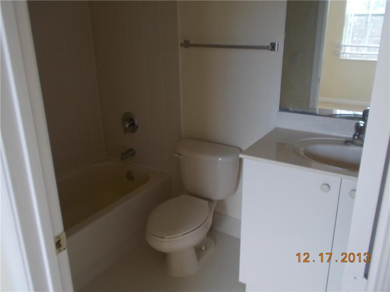 2650 Southwest 84th Terrace, Unit 105 Miramar, FL 33025 - Photo 12 of 12 a white toilet sitting next to a bath tub