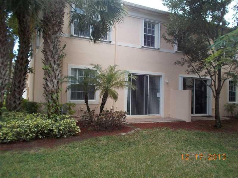 2650 Southwest 84th Terrace, Unit 105 Miramar, FL 33025 - Photo 2 of 12 a front view of a house with a garden