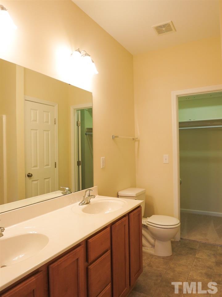 8508 Micollet Court Raleigh, NC 27613 - Photo 13 of 25 a bathroom with a granite countertop sink toilet and shower
