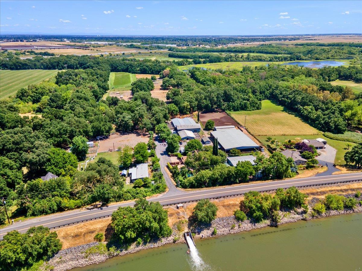 an aerial view of a city with lots of residential buildings ocean and mountain view in back