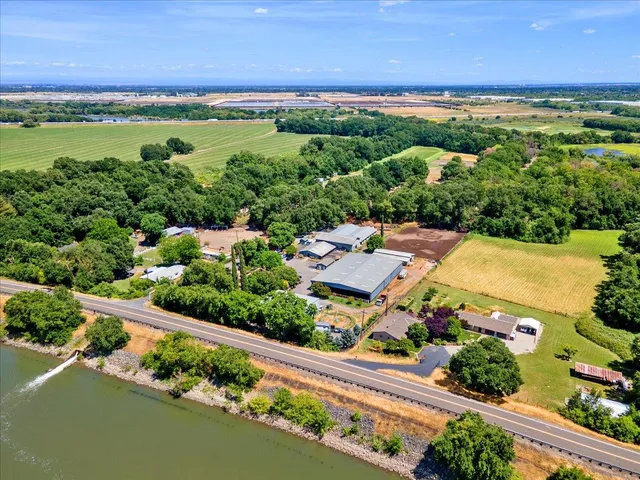 an aerial view of a city with lots of residential buildings ocean and mountain view in back