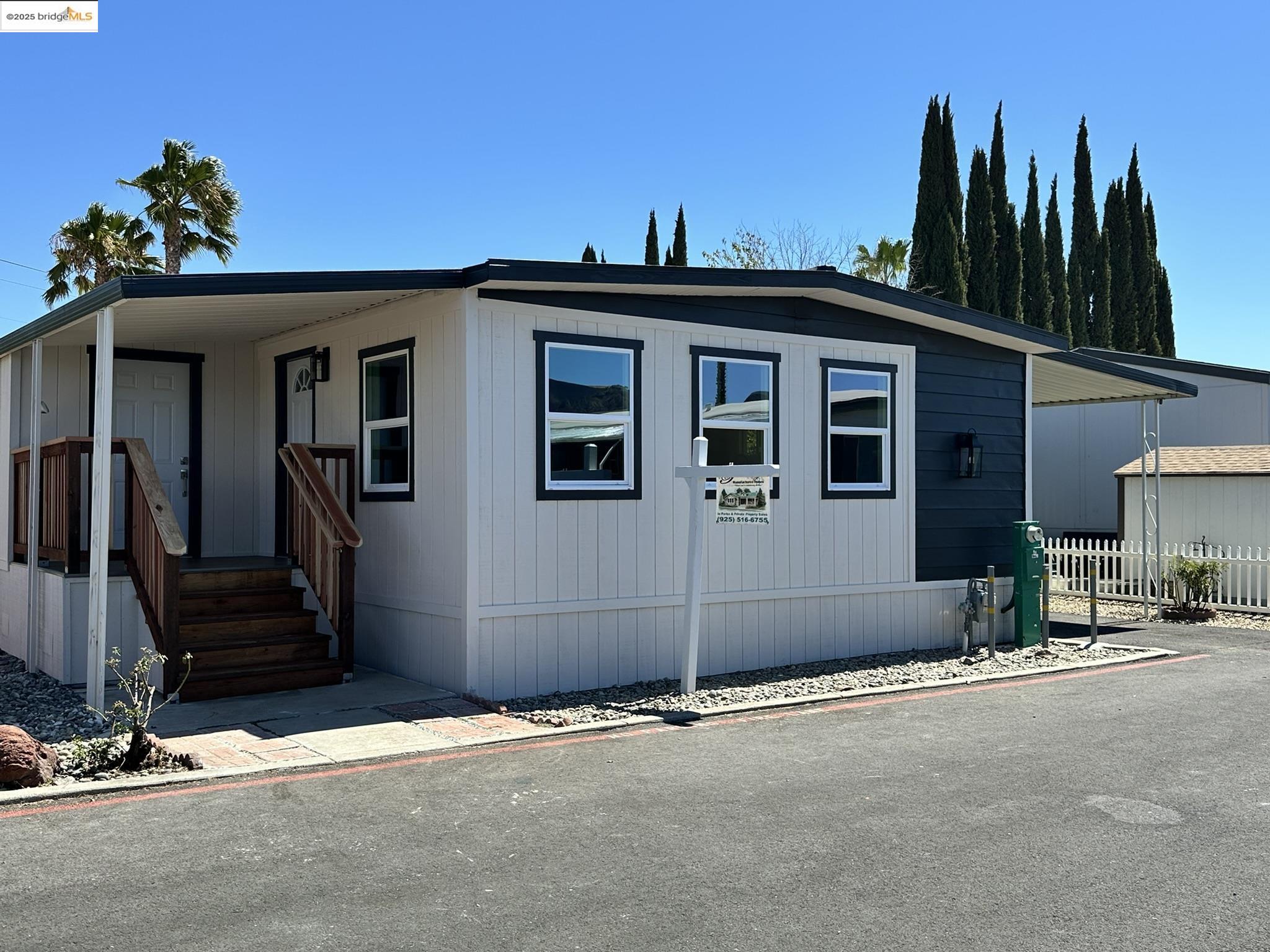 a view of a house with a wooden fence