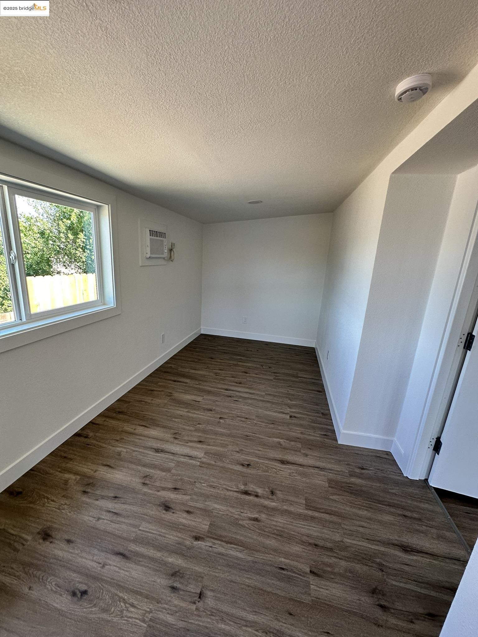 3301 Buchanan Road, Unit 47 Antioch, CA 94509 - Photo 17 of 58 an empty room with wooden floor and windows